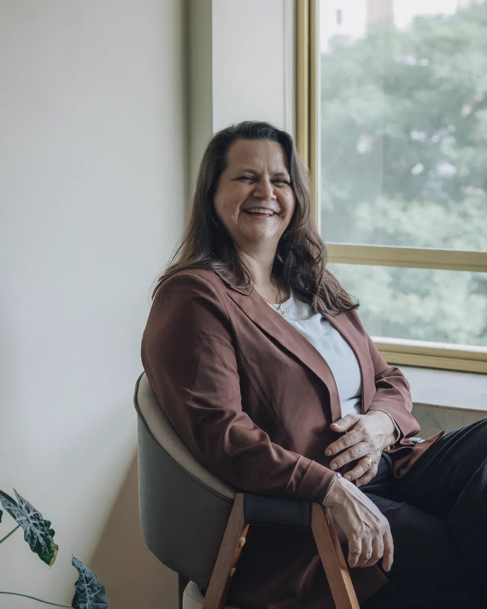 Catherine Hartwell, founding partner, seated by a window in the firm's office